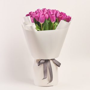 Bouquet of vibrant purple tulips wrapped elegantly, flowers theme